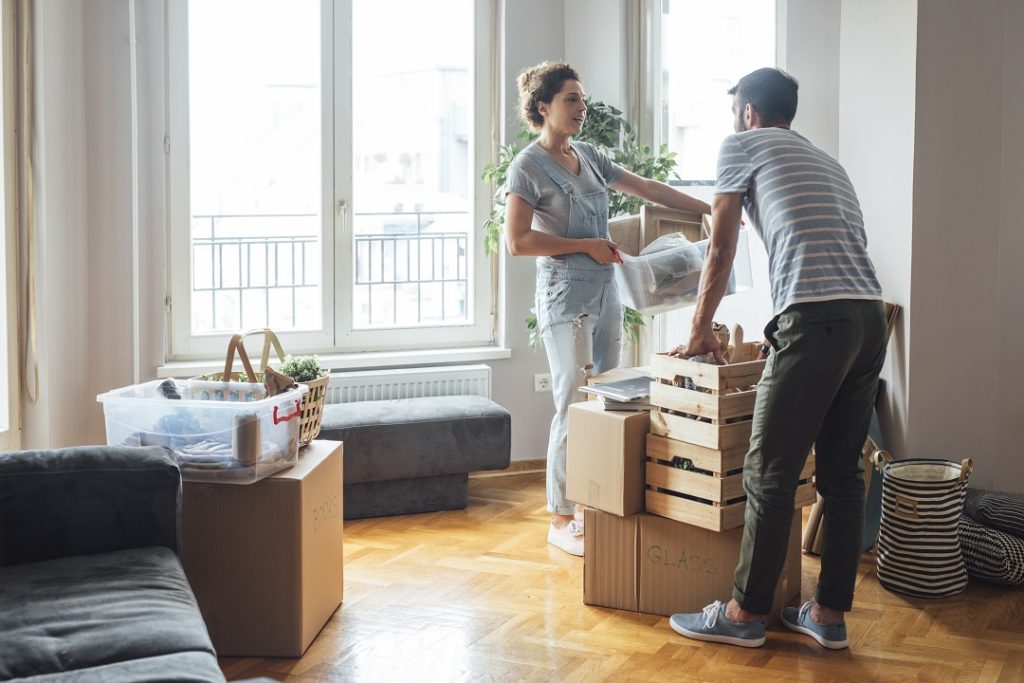  couple unpacking boxes at their new home.